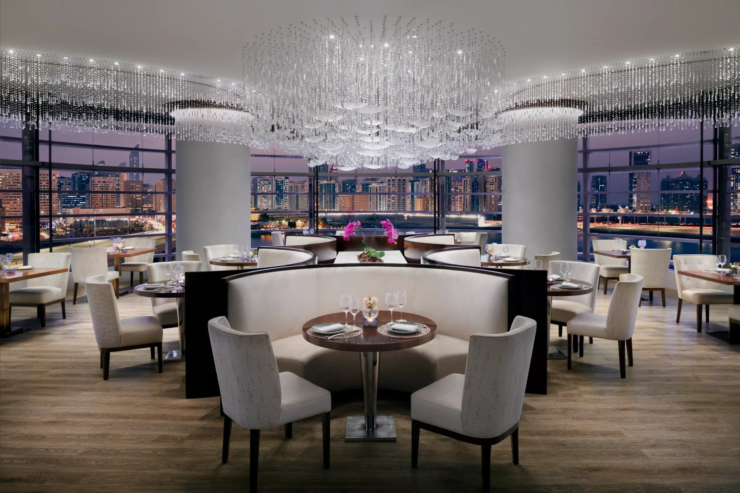 https://images.rosewoodhotels.com/is/image/rwhg/rwabu_dining_aquaevening
